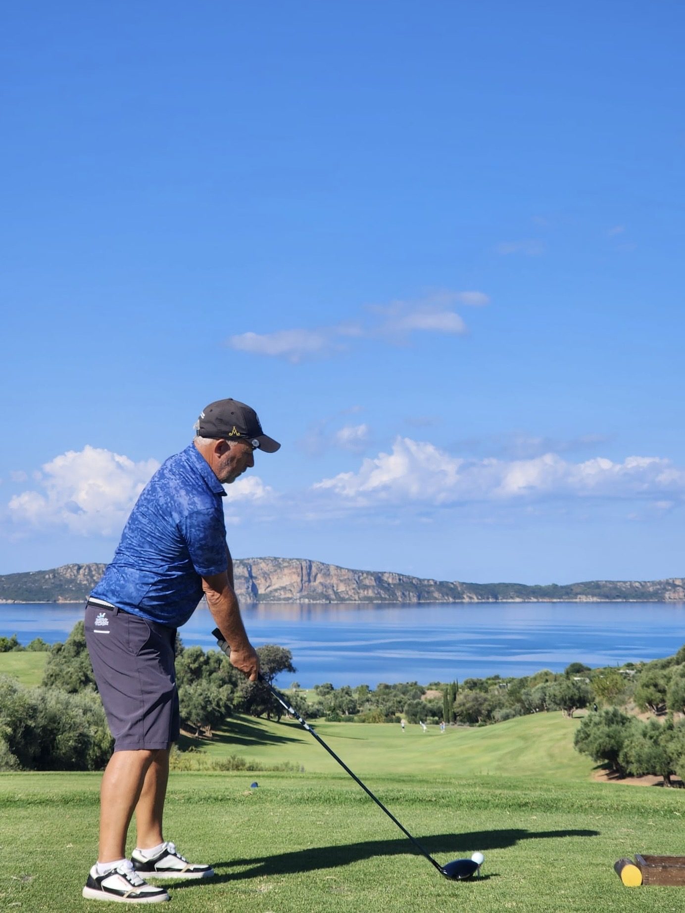 IGST member teeing off over a sea view